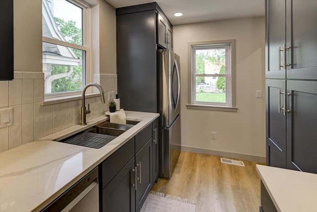 14 Wirth Ct, Madison, WI 53704 - kitchen with stainless steel appliances, a sink, healthy amount of natural light, light wood finished floors, and recessed lighting