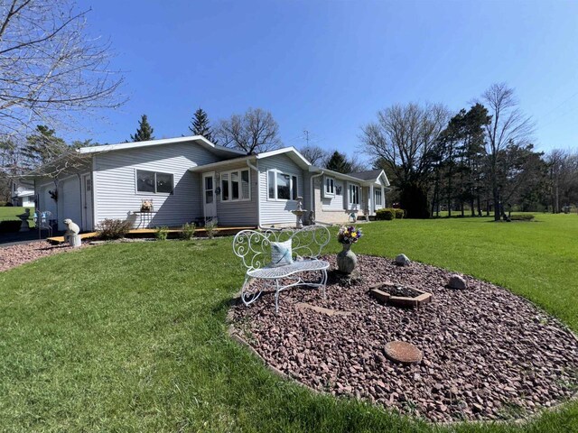 34103 Putnam St, Muscoda, WI 53573 - ranch-style house featuring an attached garage and a front lawn