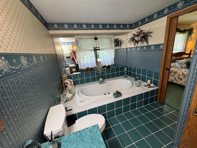 34103 Putnam St, Muscoda, WI 53573 - bathroom featuring tile patterned flooring, wainscoting, ensuite bathroom, wallpapered walls, and a bath