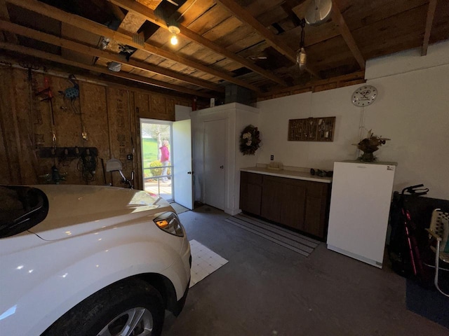 34103 Putnam St, Muscoda, WI 53573 - garage with wooden ceiling and freestanding refrigerator