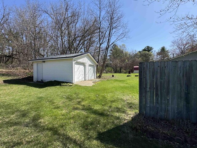 34103 Putnam St, Muscoda, WI 53573 - view of yard with fence, an outbuilding, and a garage