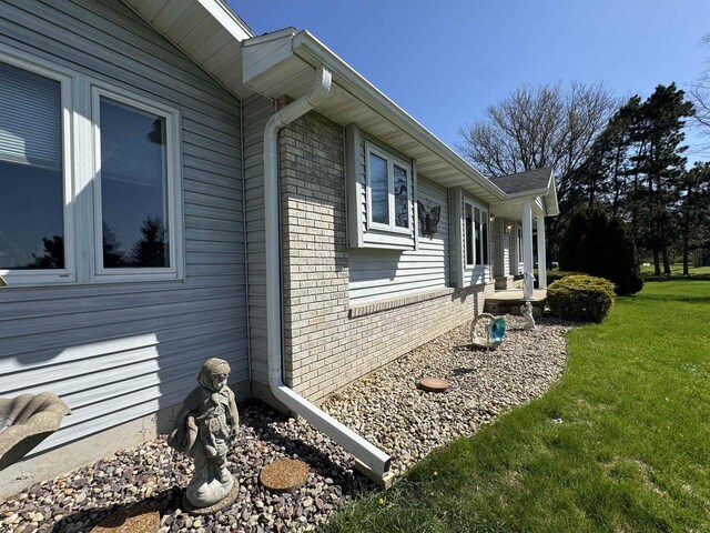 34103 Putnam St, Muscoda, WI 53573 - view of home's exterior with a lawn and brick siding