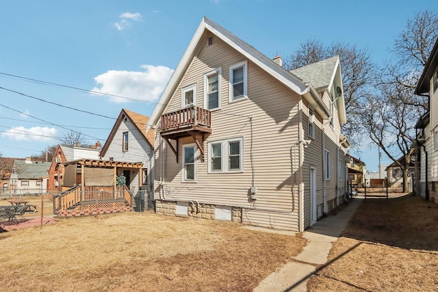 3367 N 36th St, Milwaukee, WI 53216 - view of front facade with fence, a shingled roof, and a balcony