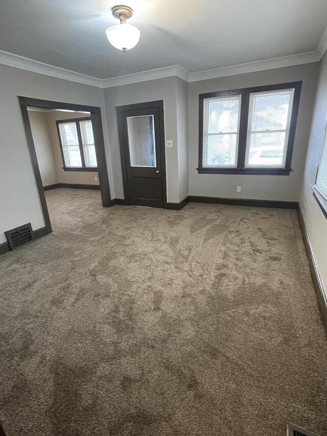 3367 N 36th St, Milwaukee, WI 53216 - carpeted entryway with visible vents, baseboards, and crown molding