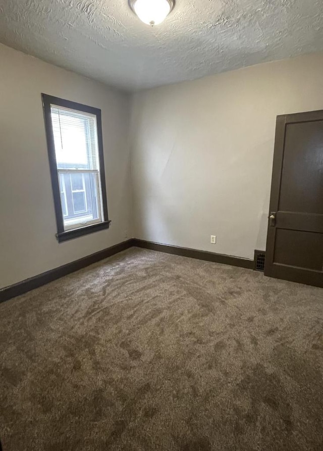 3367 N 36th St, Milwaukee, WI 53216 - carpeted spare room with a textured ceiling and baseboards