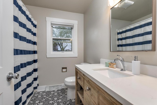 bathroom featuring visible vents, tile patterned flooring, vanity, baseboards, and toilet
