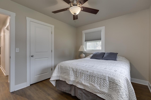 bedroom with baseboards, ceiling fan, and wood finished floors