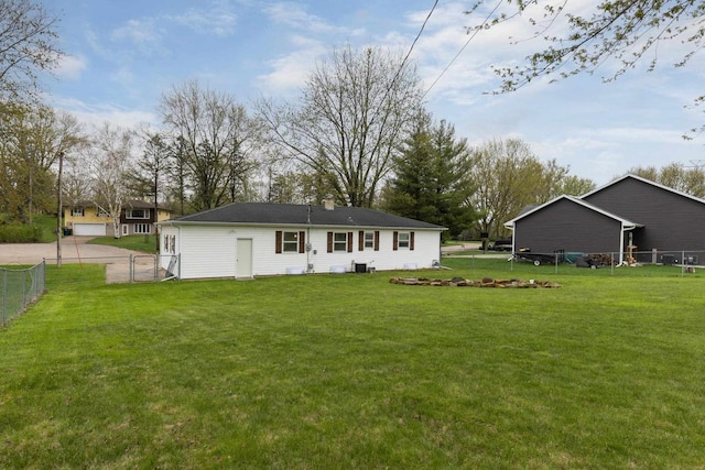 back of house with a lawn and fence