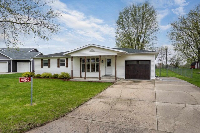 single story home with fence, a garage, a front yard, covered porch, and driveway