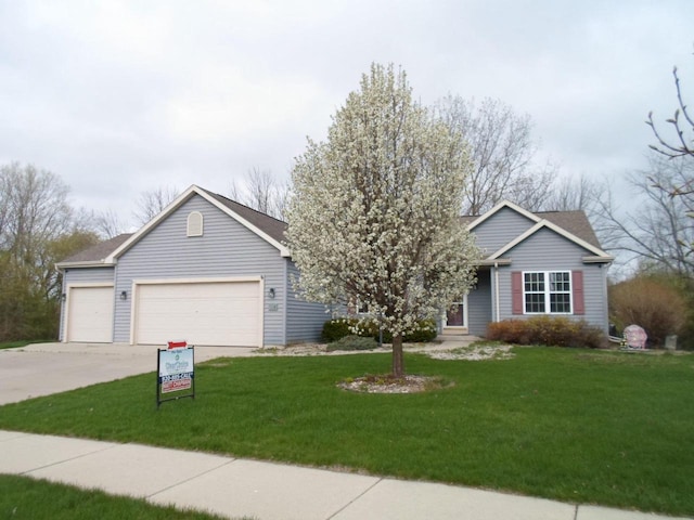 ranch-style home featuring an attached garage, driveway, and a front lawn