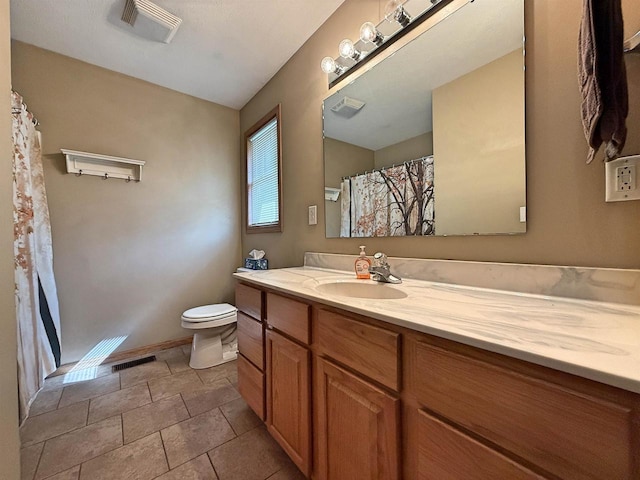 bathroom featuring visible vents, toilet, and vanity