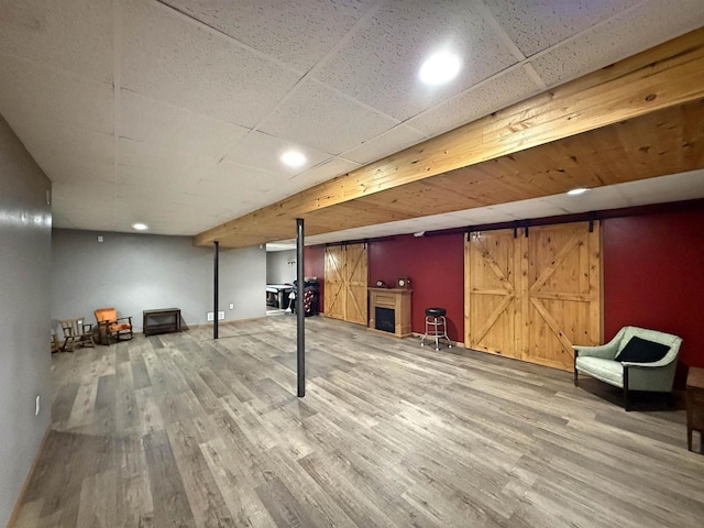 finished basement with recessed lighting and wood finished floors
