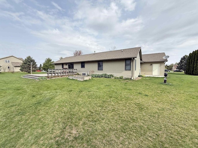 rear view of property with a patio area and a yard