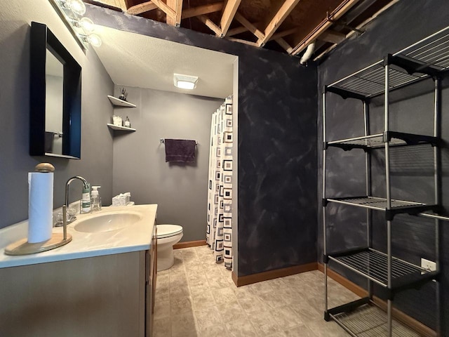 bathroom featuring toilet, baseboards, curtained shower, and vanity