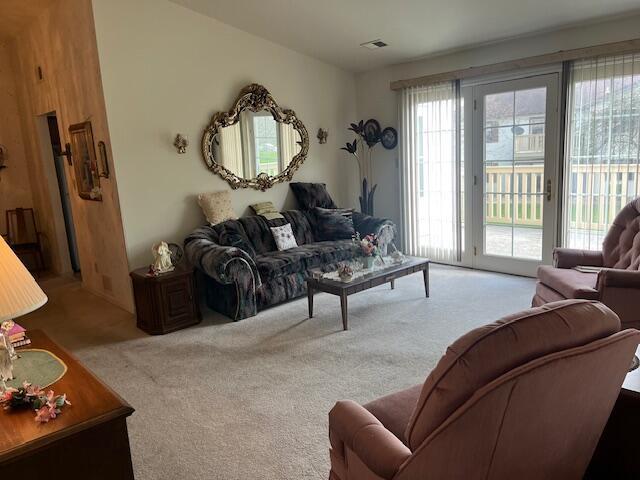 carpeted living room featuring visible vents