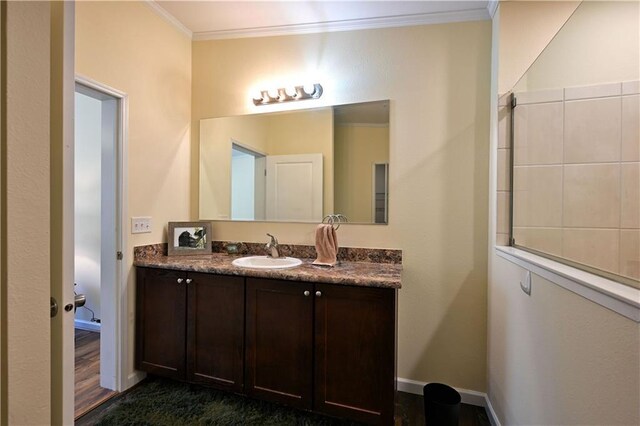 13585 Oswald Rd, Drummond, WI 54832 - bathroom featuring baseboards, ornamental molding, and vanity