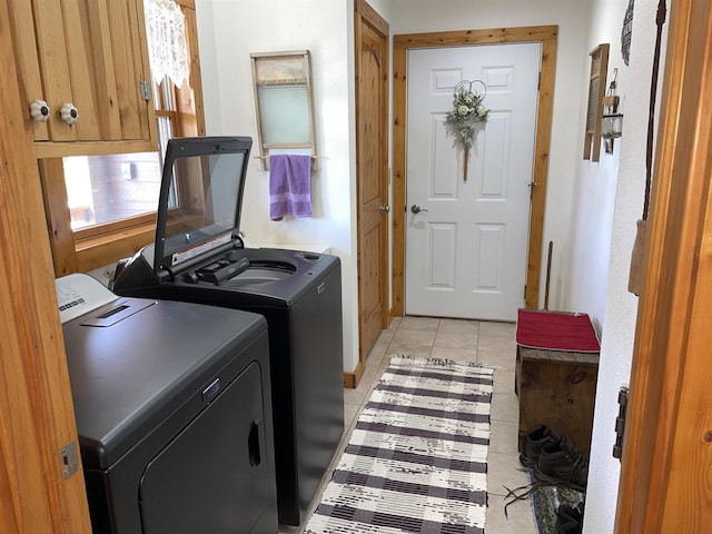 laundry area featuring light tile patterned floors, laundry area, and independent washer and dryer