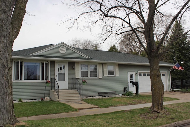 436 Roosevelt St, Fond Du Lac, WI 54935 - view of front facade featuring a garage, driveway, entry steps, a front lawn, and roof with shingles