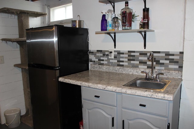 436 Roosevelt St, Fond Du Lac, WI 54935 - kitchen with open shelves, a sink, freestanding refrigerator, and light countertops