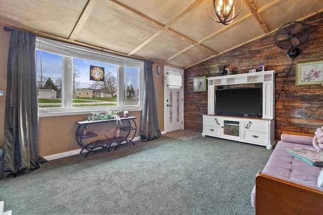 living room with wooden walls, baseboards, vaulted ceiling, and carpet flooring
