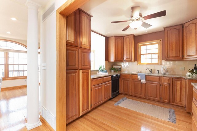 W347N5904 Lake Dr, Oconomowoc, WI 53066 - kitchen featuring visible vents, decorative columns, black dishwasher, brown cabinets, and light wood finished floors