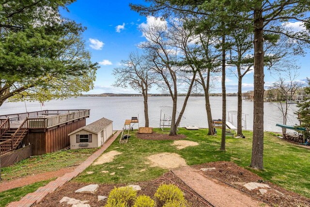 W347N5904 Lake Dr, Oconomowoc, WI 53066 - view of yard featuring a water view, a shed, and an outbuilding