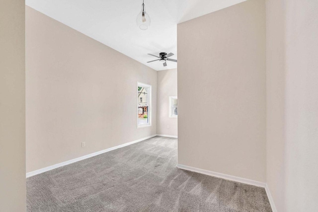 empty room with baseboards, carpet, and ceiling fan