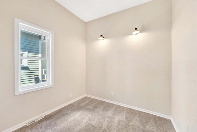carpeted empty room with baseboards and visible vents