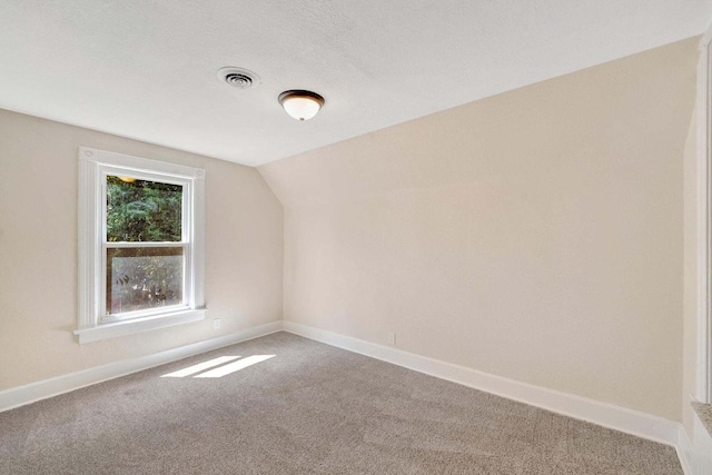 bonus room with carpet floors, baseboards, visible vents, and lofted ceiling