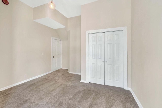 unfurnished bedroom with carpet floors, baseboards, and a closet