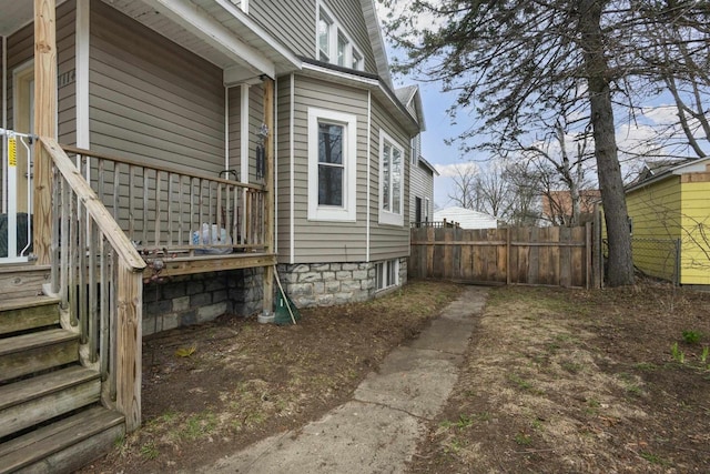 view of side of home featuring fence