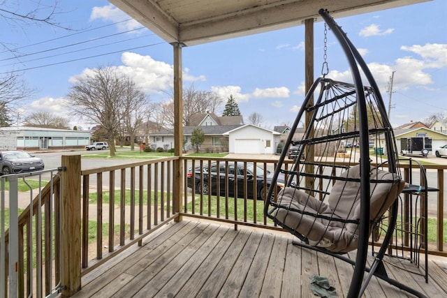 deck with a porch, a garage, and a residential view