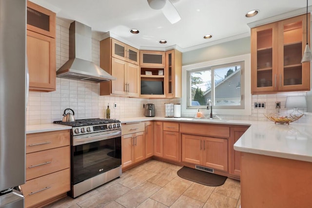 1517 Torrison Dr, Manitowoc, WI 54220 - kitchen featuring wall chimney range hood, appliances with stainless steel finishes, a sink, tasteful backsplash, and light countertops