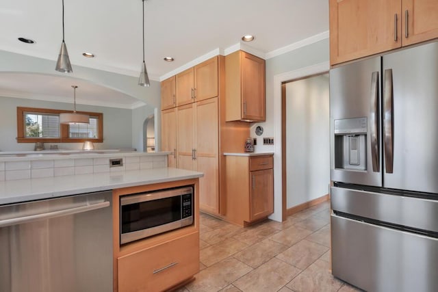 1517 Torrison Dr, Manitowoc, WI 54220 - kitchen with stainless steel appliances, crown molding, arched walkways, light countertops, and pendant lighting
