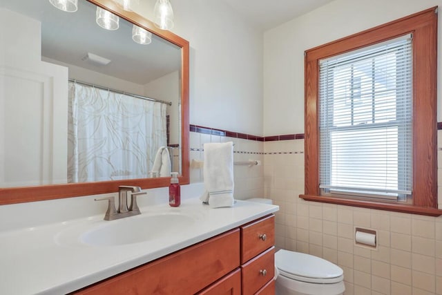 1517 Torrison Dr, Manitowoc, WI 54220 - bathroom with vanity, tile walls, toilet, healthy amount of natural light, and a shower with curtain