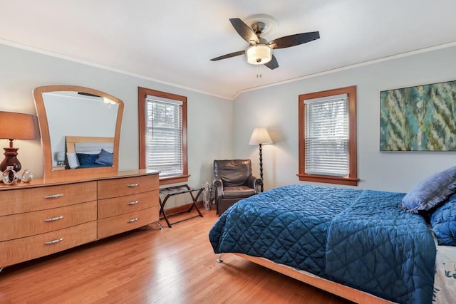 1517 Torrison Dr, Manitowoc, WI 54220 - bedroom with ornamental molding, light wood finished floors, multiple windows, and a ceiling fan