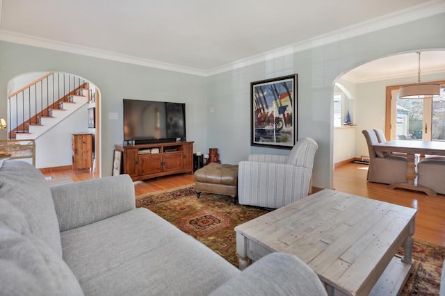 1517 Torrison Dr, Manitowoc, WI 54220 - living room with arched walkways, ornamental molding, wood finished floors, stairway, and baseboards