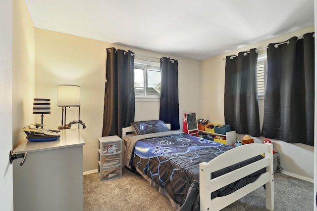 carpeted bedroom featuring baseboards