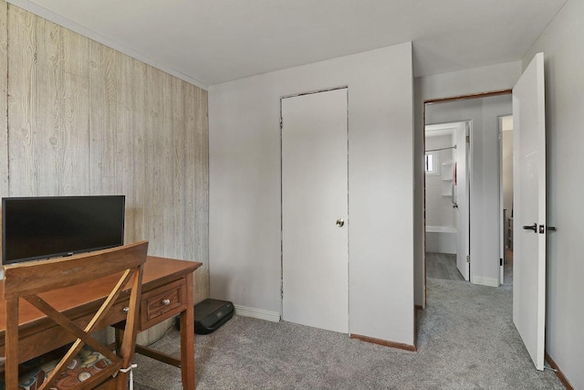 carpeted office space featuring baseboards