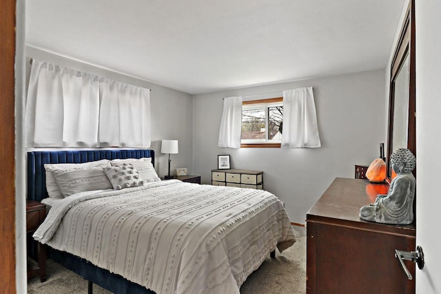 carpeted bedroom featuring baseboards