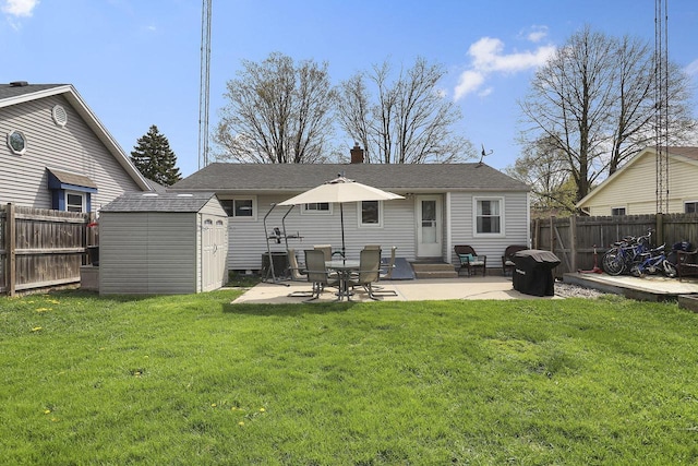 back of property featuring a fenced backyard, a patio, an outdoor structure, and a shed