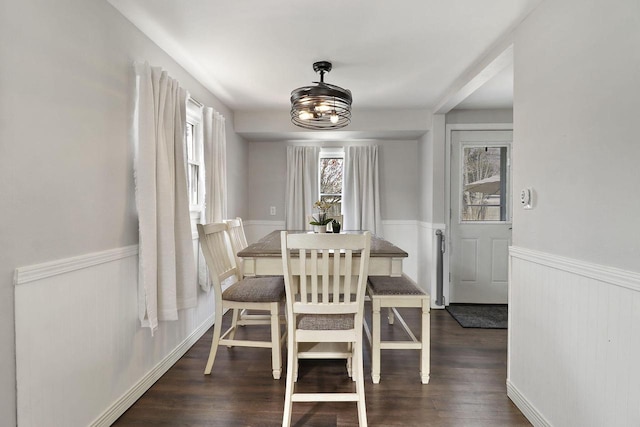 dining room with wainscoting and wood finished floors