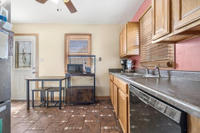 kitchen with a ceiling fan, dark countertops, a sink, baseboards, and black appliances