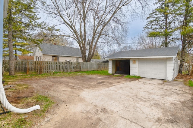 detached garage featuring fence