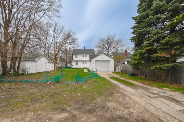 view of front of property with a front lawn, fence, driveway, and a chimney