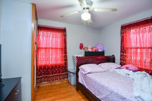 bedroom with a ceiling fan and wood finished floors