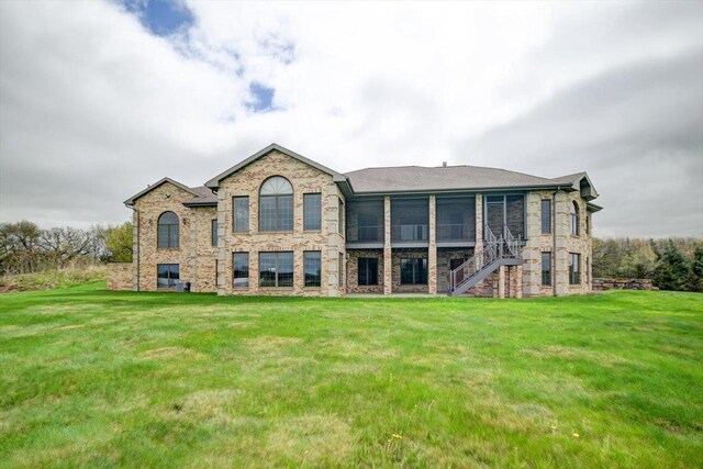 457 Union Rd, Brooklyn, WI 53521 - back of house with a lawn, stone siding, and a sunroom