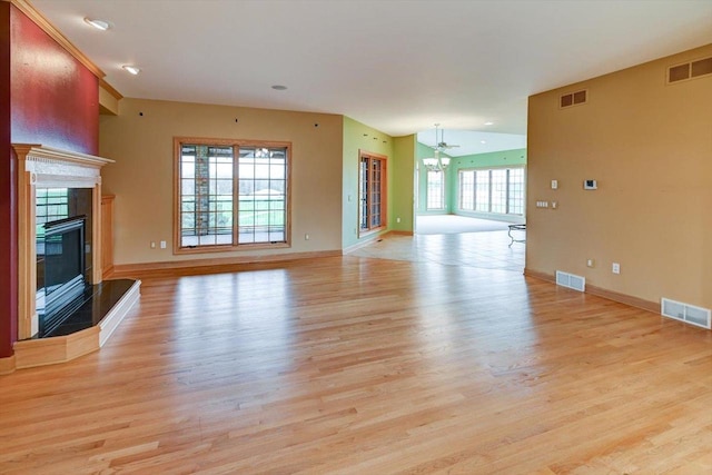 457 Union Rd, Brooklyn, WI 53521 - unfurnished living room featuring visible vents, a tiled fireplace, and light wood-type flooring