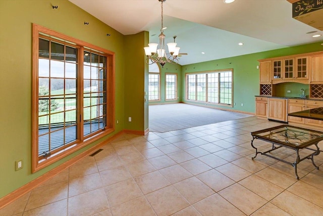 457 Union Rd, Brooklyn, WI 53521 - interior space featuring baseboards, light tile patterned floors, a chandelier, and vaulted ceiling