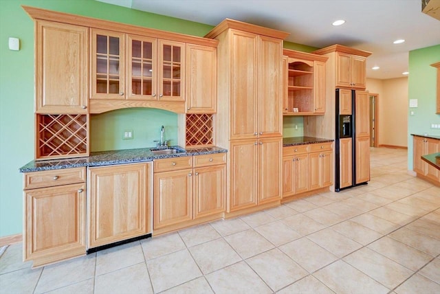 457 Union Rd, Brooklyn, WI 53521 - kitchen featuring backsplash, light brown cabinetry, a sink, dark stone countertops, and paneled built in fridge